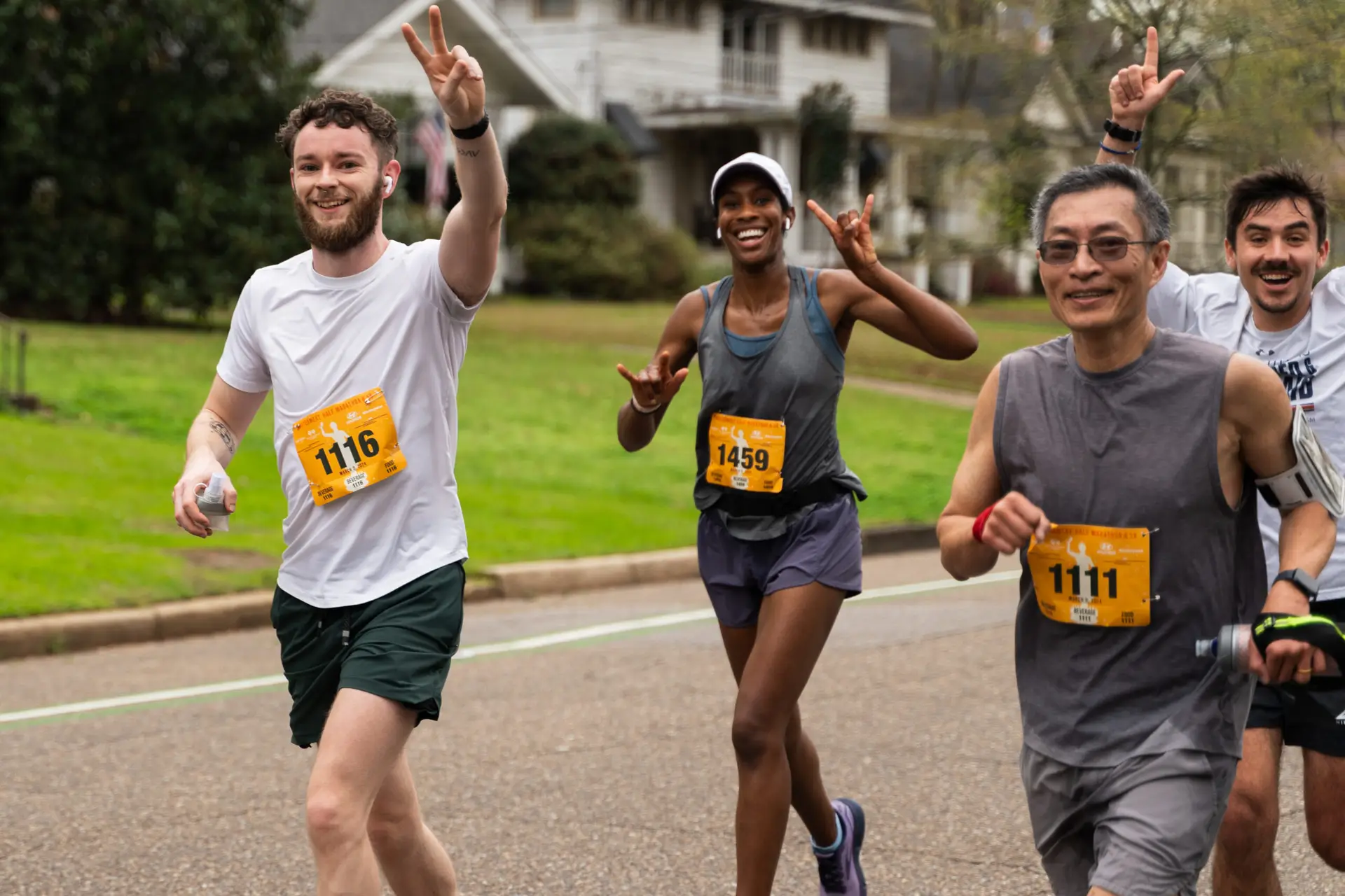 Four runners on street in neighborhood